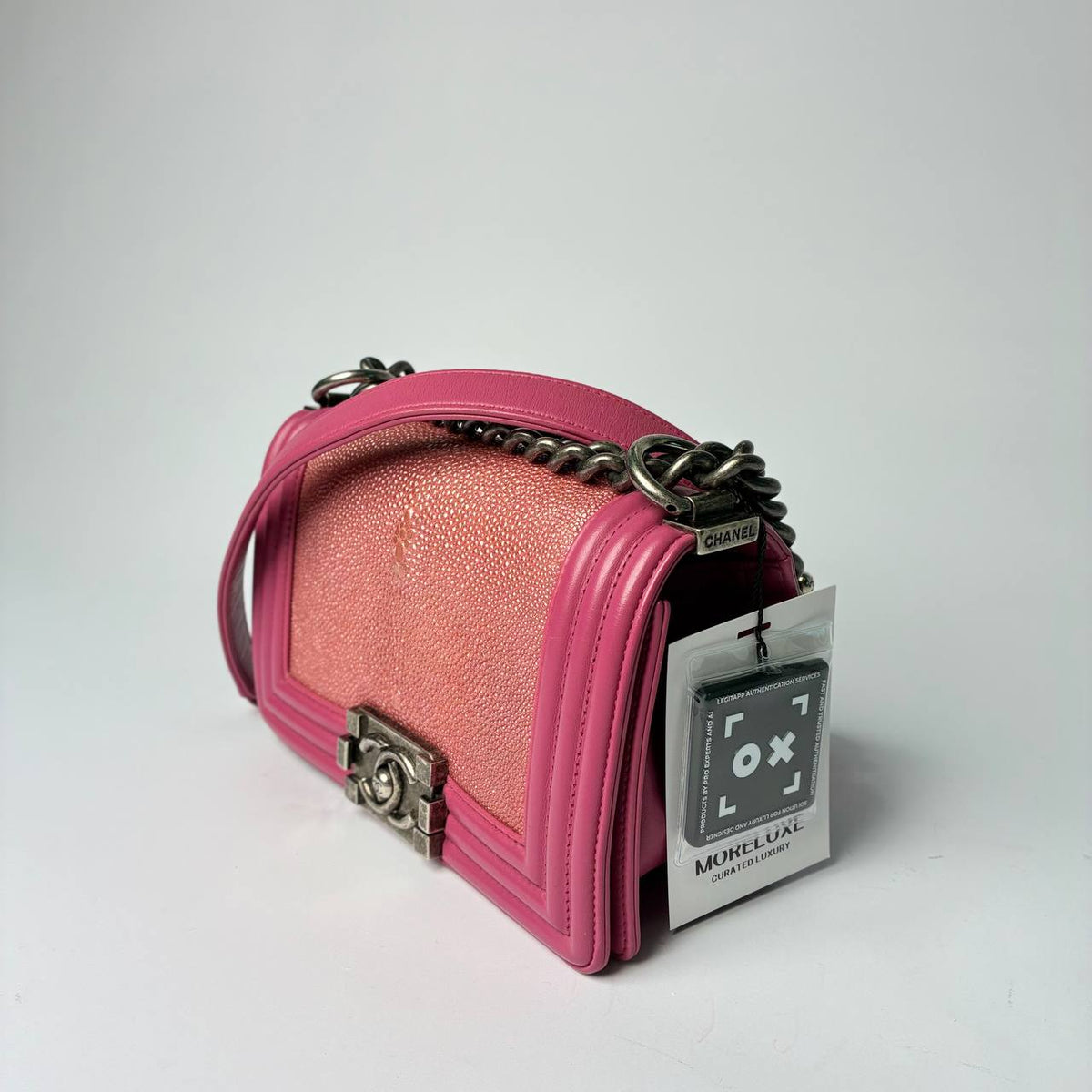 Chanel Boy Bag pink galuchat, three-quarter side view with chain strap and hang tag