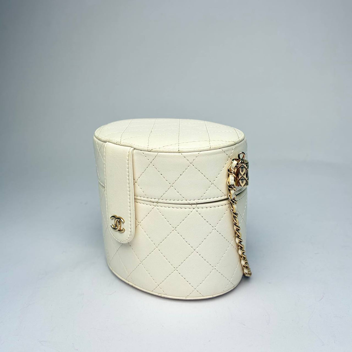 Chanel Round Mini Vanity Case white, three-quarter view showing the CC tab and leather-woven chain