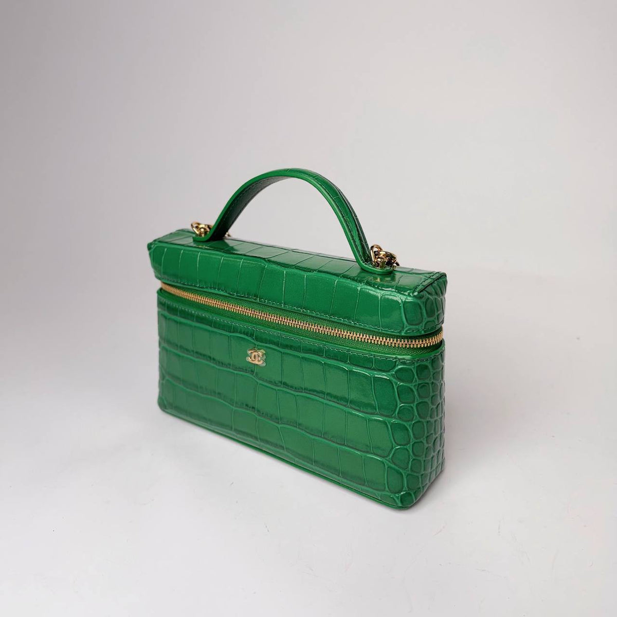 Chanel Slim Vanity Case green, three-quarter view showing the top handle and zip-around opening