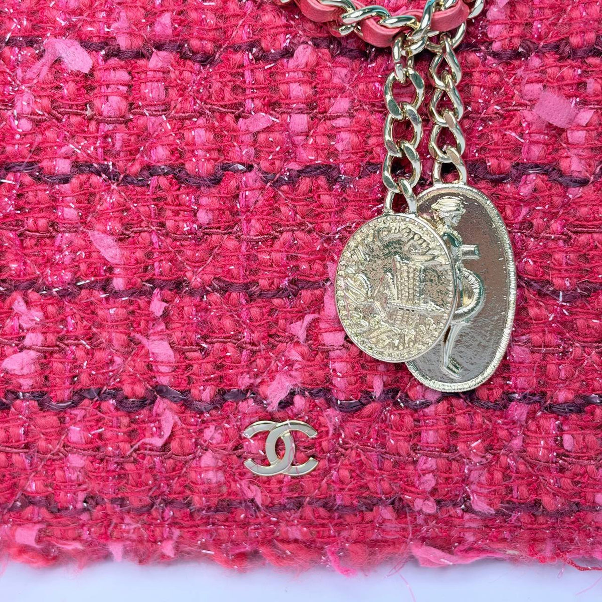 Chanel Tweed Wallet on Chain, close-up of the engraved coin charms and small CC logo