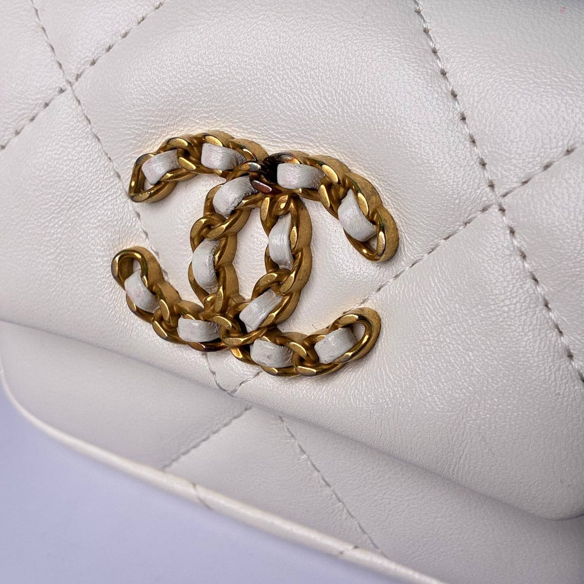 Chanel 19 Flap Card Holder white, close-up of leather-woven CC logo