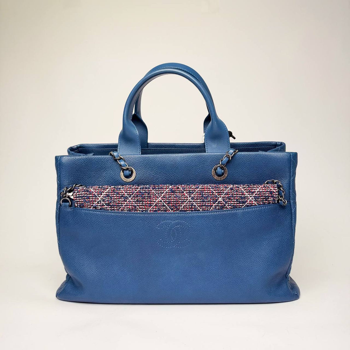 Chanel Coco Break Shopping Tote in blue caviar leather with a tweed front pocket and leather-threaded chains, front view