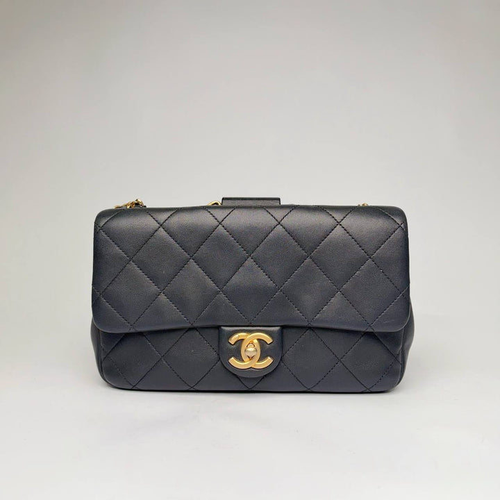 Chanel quilted flap bag in black lambskin with aged gold-tone CC turnlock and chain, front view