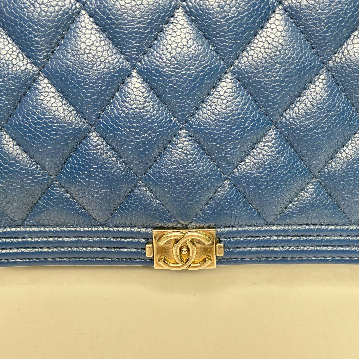 Chanel Boy Wallet blue caviar, close-up of caviar grain and Boy clasp