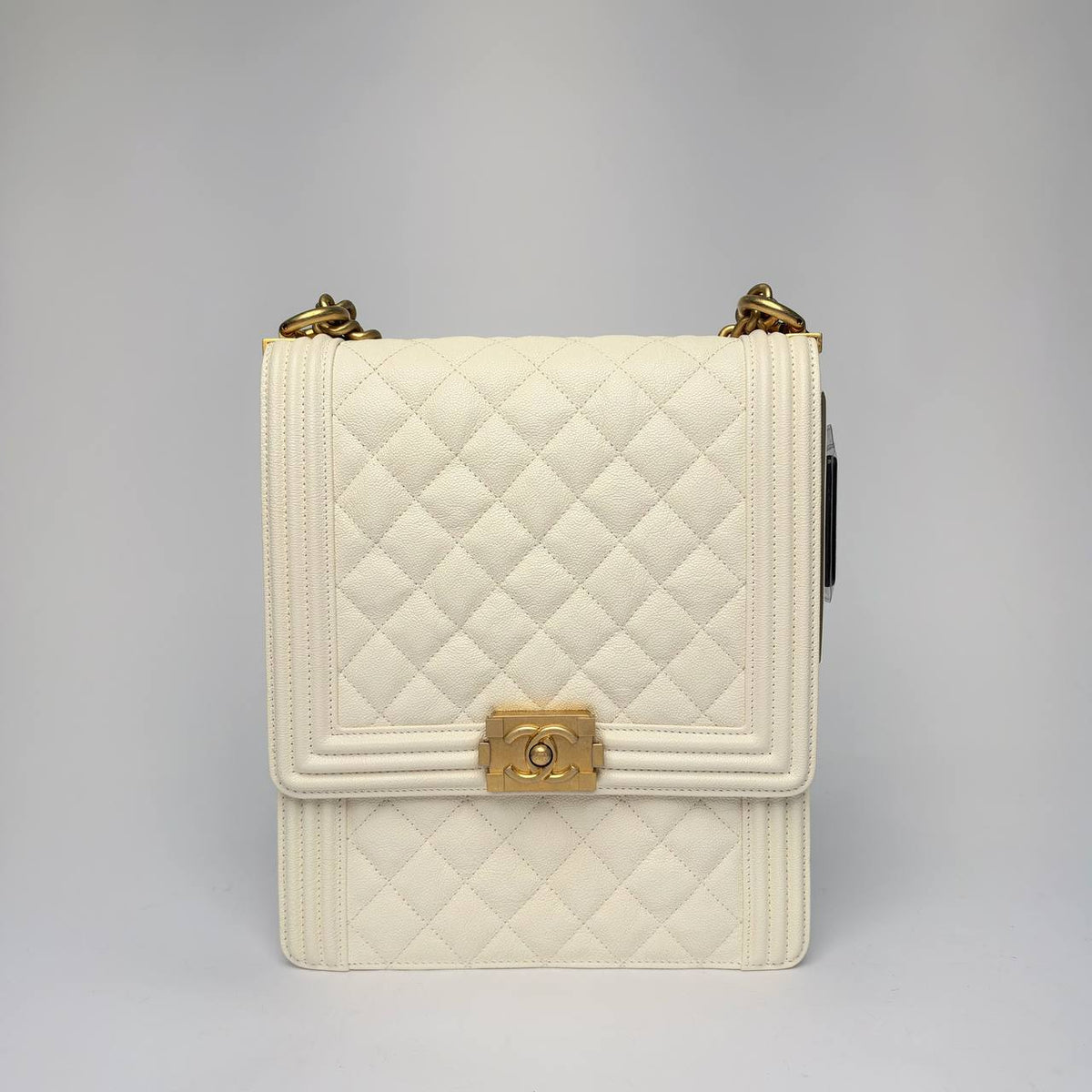 Chanel North South Boy Bag in white quilted caviar leather with gold hardware, front view