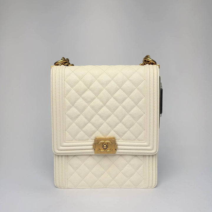 Chanel North South Boy Bag in white quilted caviar leather with gold hardware, front view