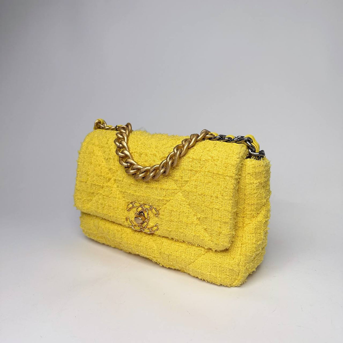 Chanel 19 Small Flap Bag yellow tweed, angled side view with mixed-metal chain