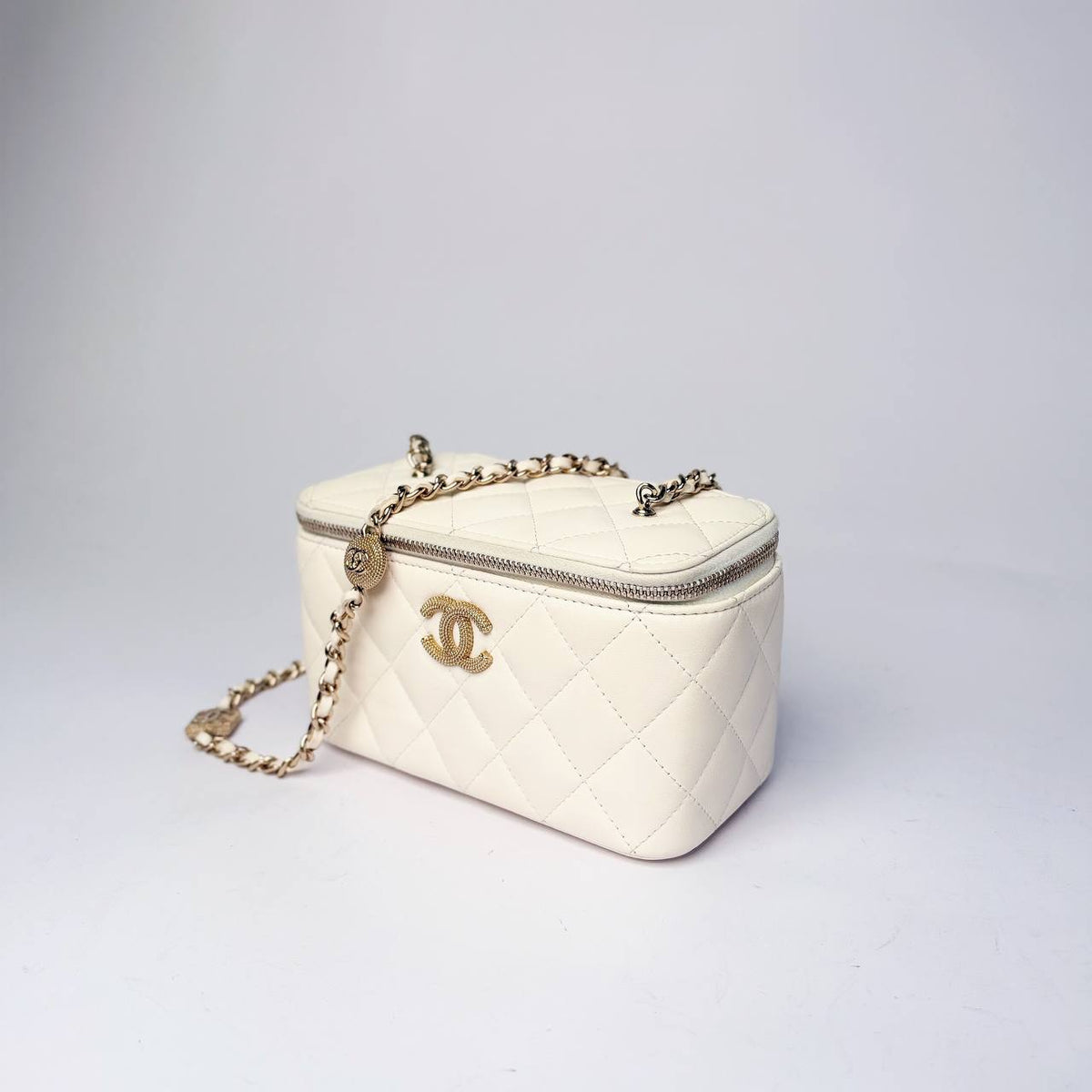Chanel Vanity Case white leather, angled side view with chain