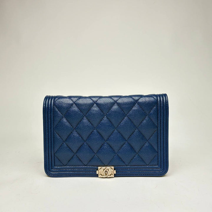 Chanel Boy Wallet in blue quilted caviar leather with light gold-tone Boy clasp, front view
