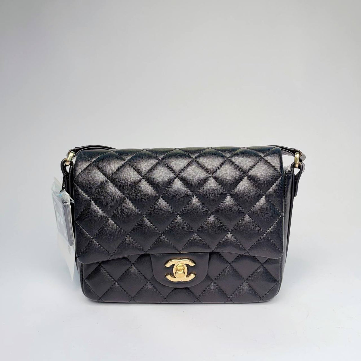 Chanel quilted flap bag in black leather with gold-tone CC turnlock and leather strap, front view
