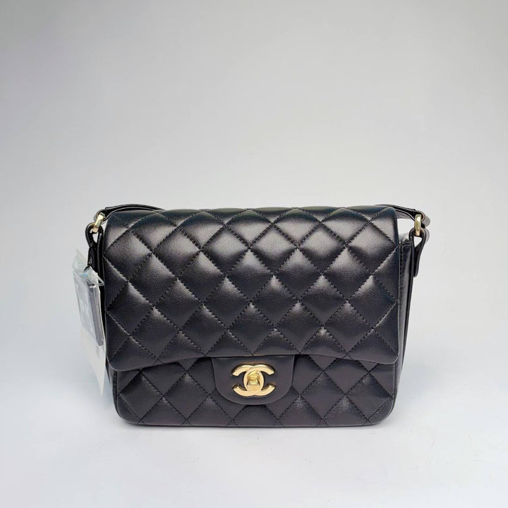 Chanel quilted flap bag in black leather with gold-tone CC turnlock and leather strap, front view