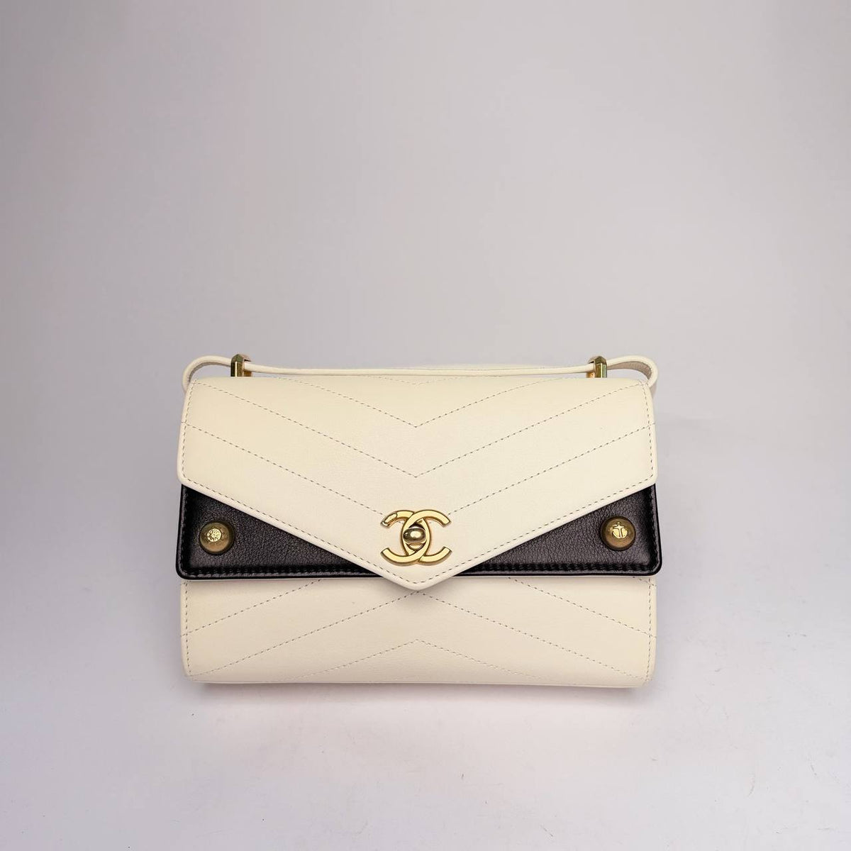 Chanel Chevron Envelope Flap Bag in white chevron leather with black side panels and gold-tone CC, front view
