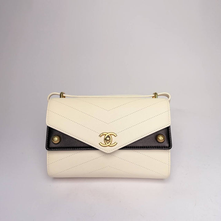 Chanel Chevron Envelope Flap Bag in white chevron leather with black side panels and gold-tone CC, front view