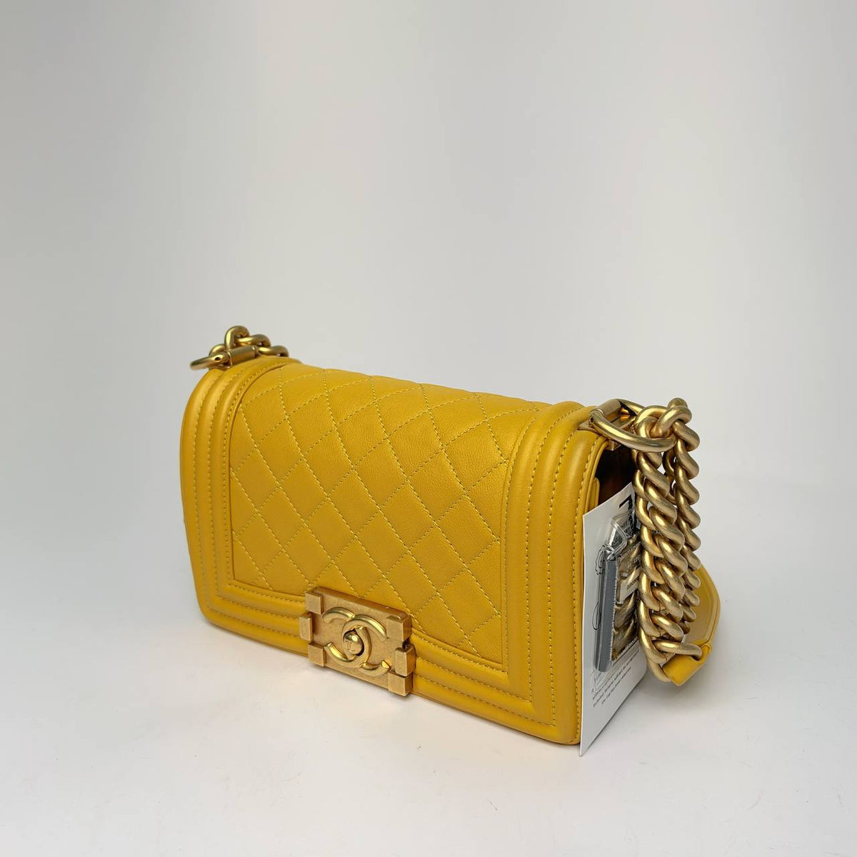 Chanel Boy Bag yellow, angled side view with chain strap