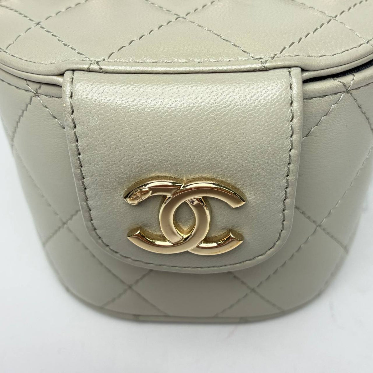Chanel Mini Vanity Case, close-up of the gold-tone CC logo on the snap tab