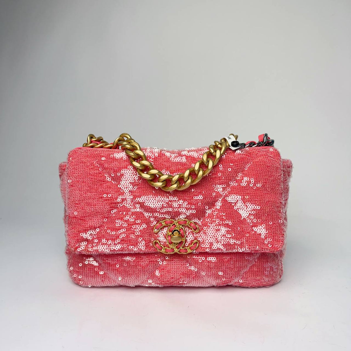 Chanel 19 Flap Bag in coral pink sequins with chunky gold-tone chain handle, front view
